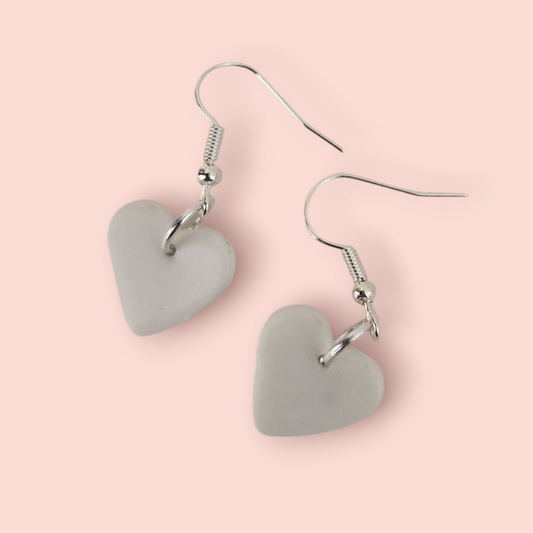 A pair of heart-shaped earrings made of paper in shades of blue and purple