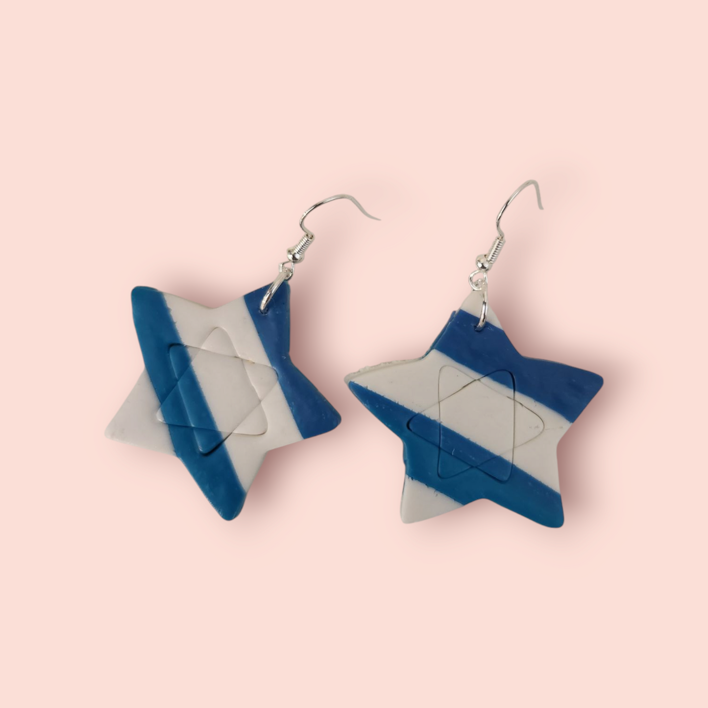 A pair of purple star-shaped earrings with intricate geometric patterns, hanging from fishhook clasps.