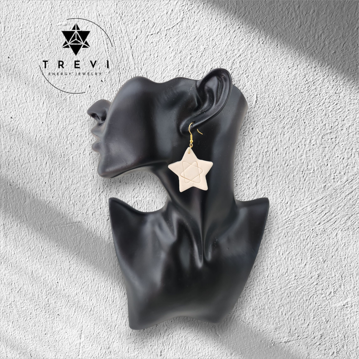 A gold-colored star earring.