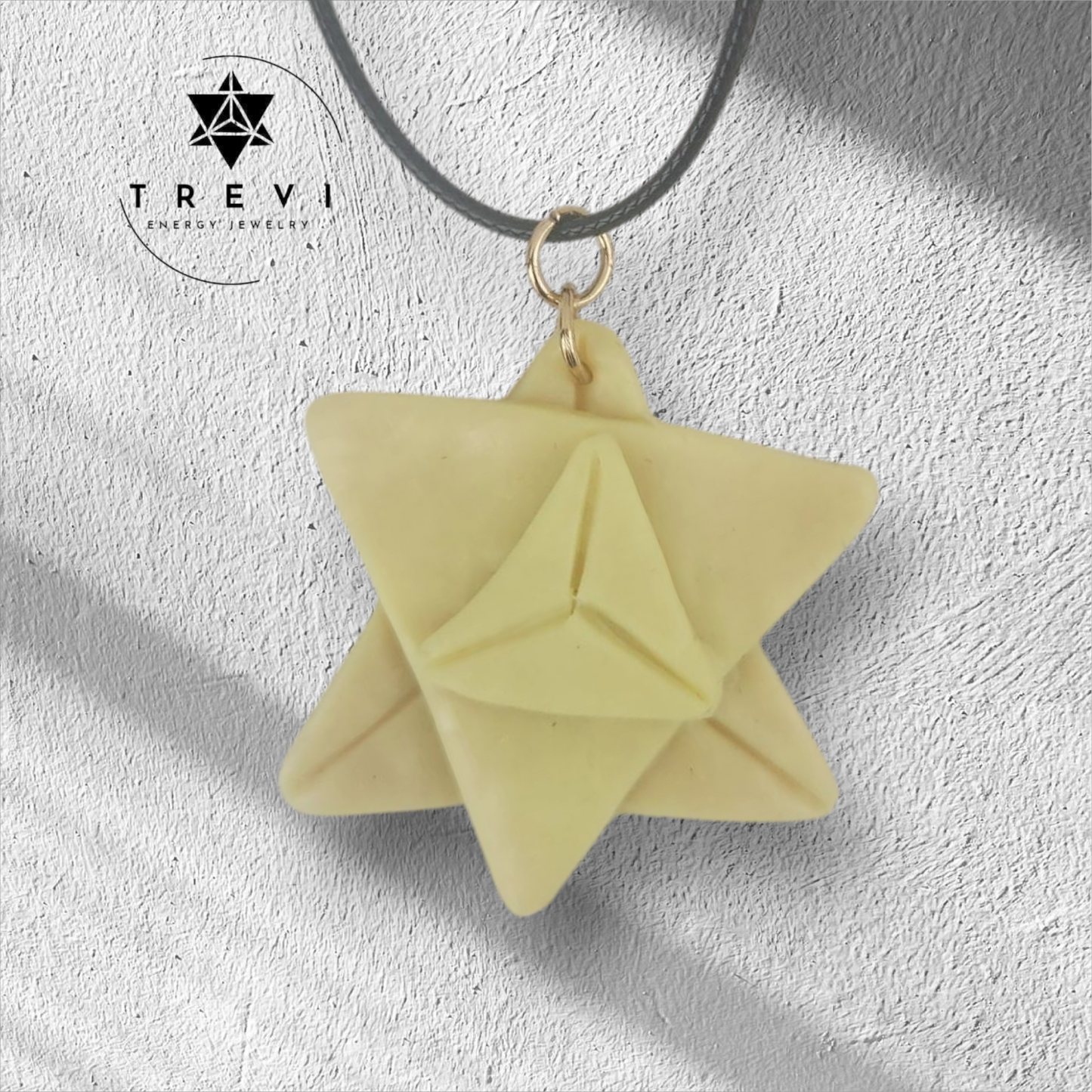 A handcrafted geometric merkaba pendant in white and pink colors.