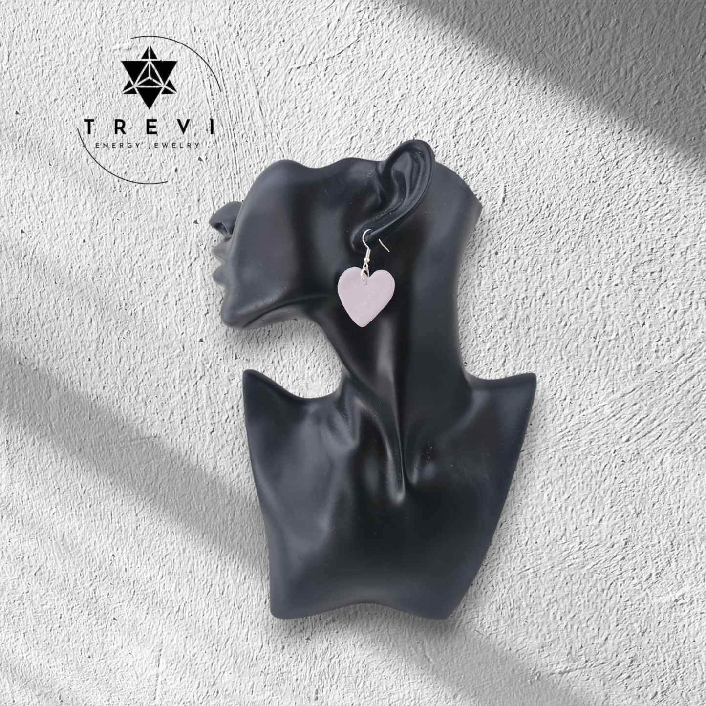 A heart-shaped pink earring.