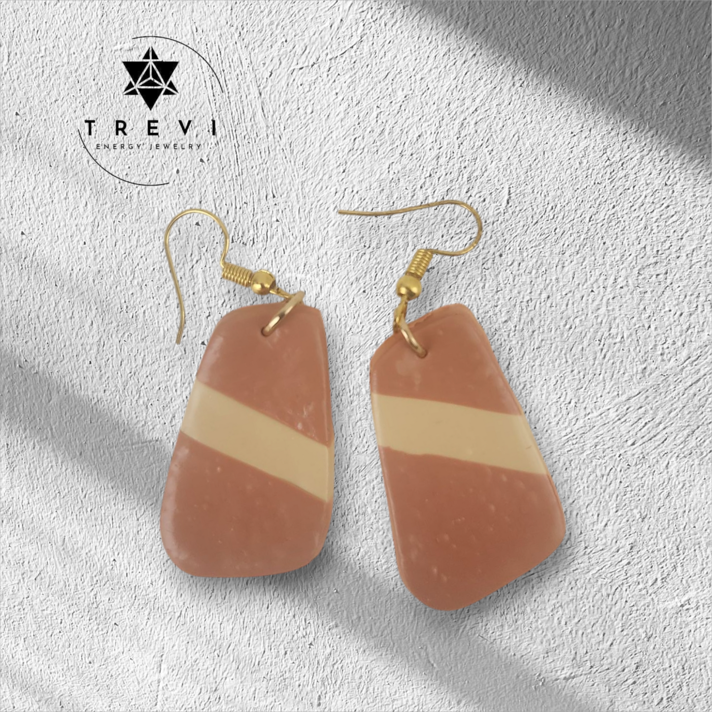 A pair of drop earrings with brown and cream striped pendants.