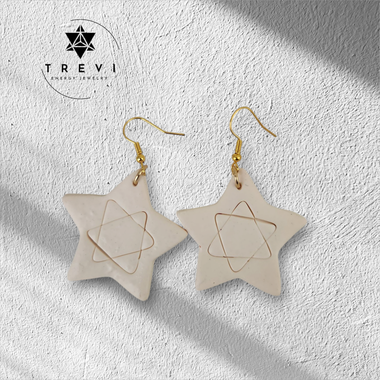 A pair of star-shaped earrings with intricate geometric patterns.