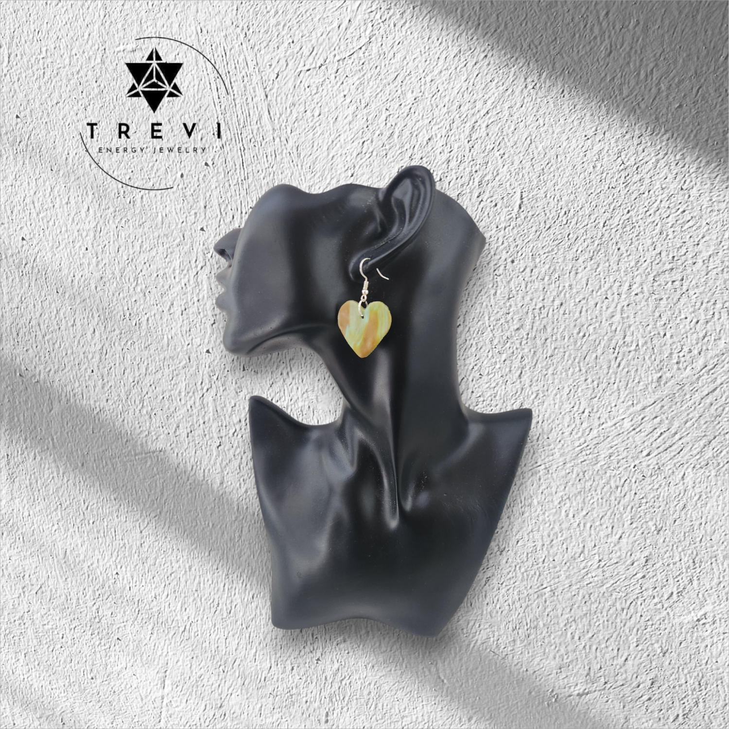 Heart-shaped brown and green earring.