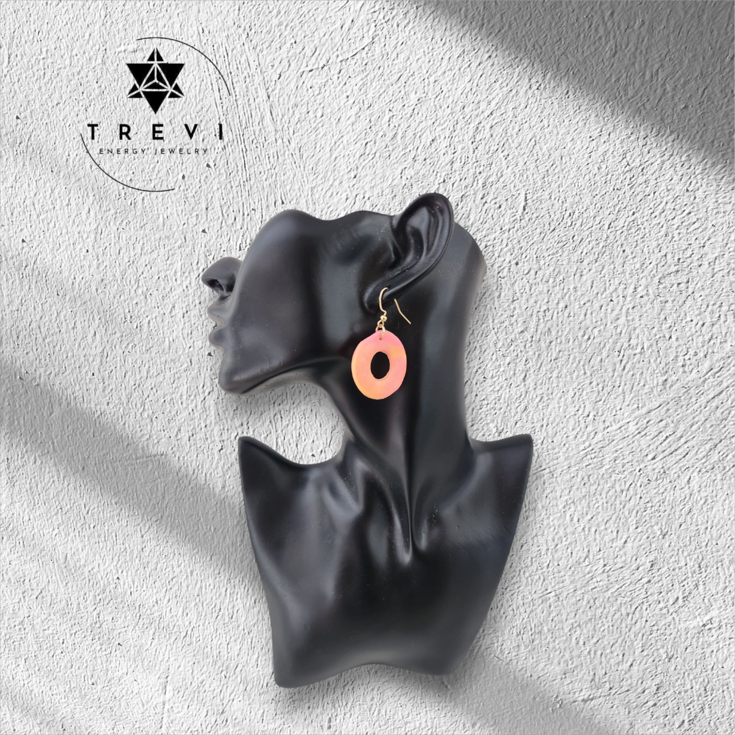 Pink and orange circular earring.