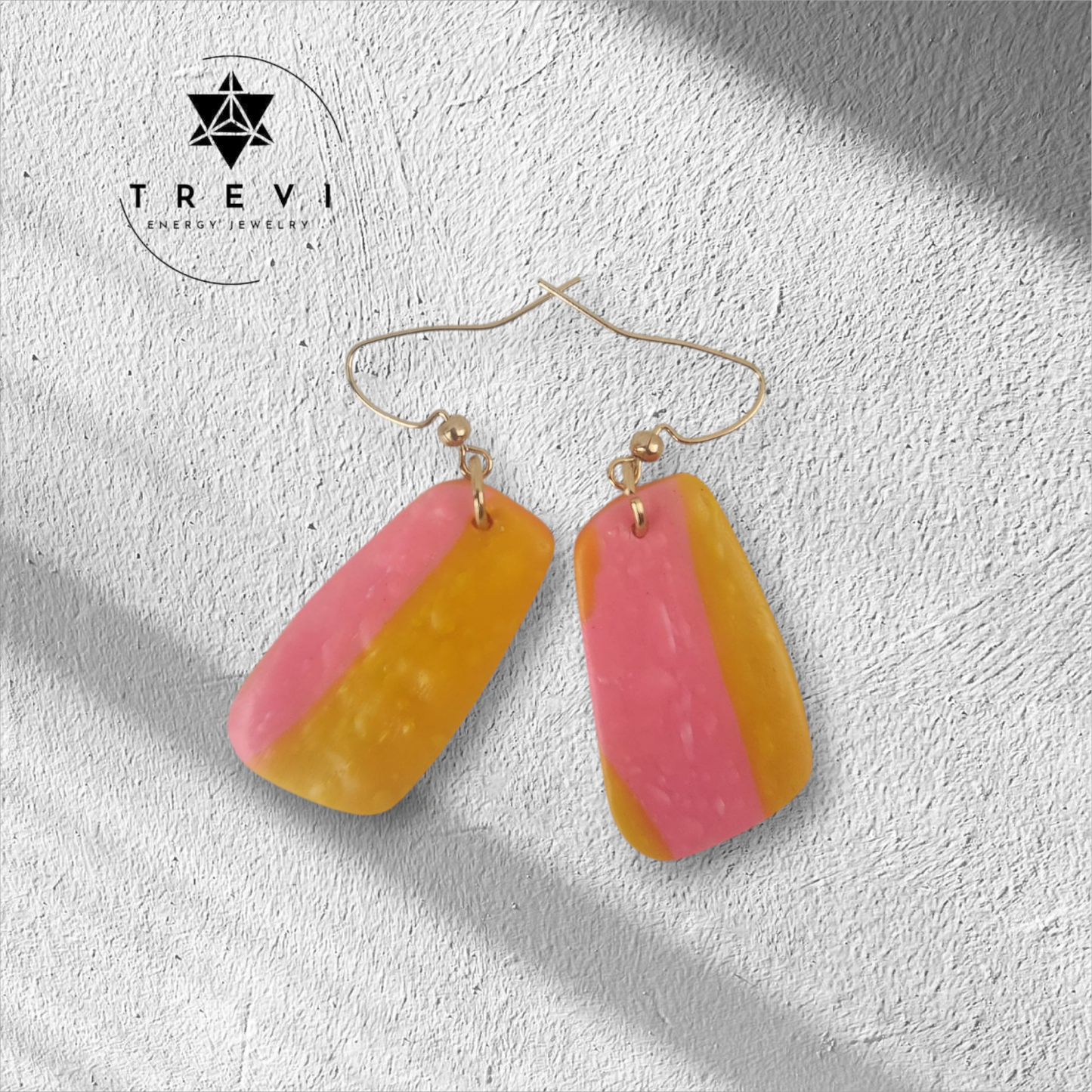 A pair of drop earrings with pink and orange striped pendants.
