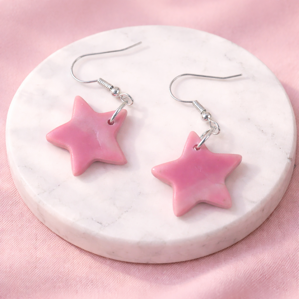 pink star earrings on marble tray sacred geometry jewelry
